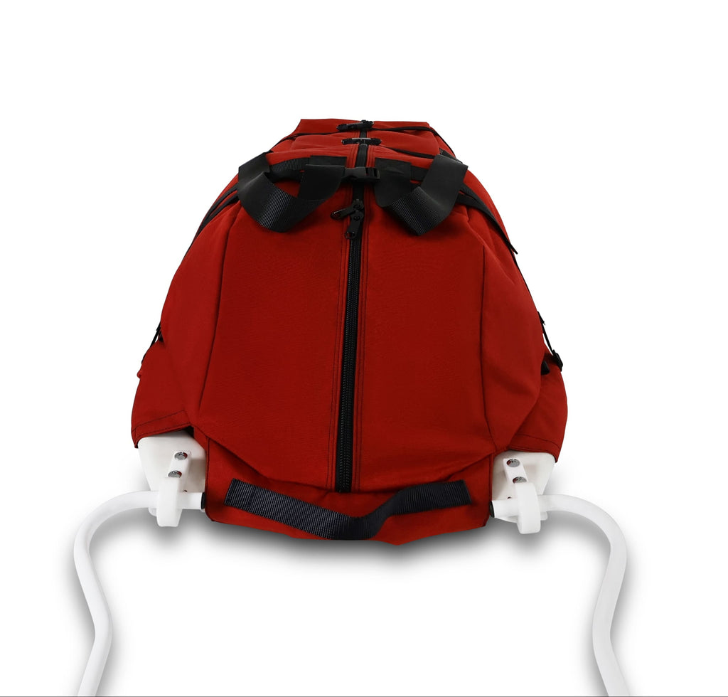 An Red snowmobile Sled Pulk cargo bag with black straps and a white plastic base, shown on a white studio background. With a tag labeled 'Wilderness Engineering'.