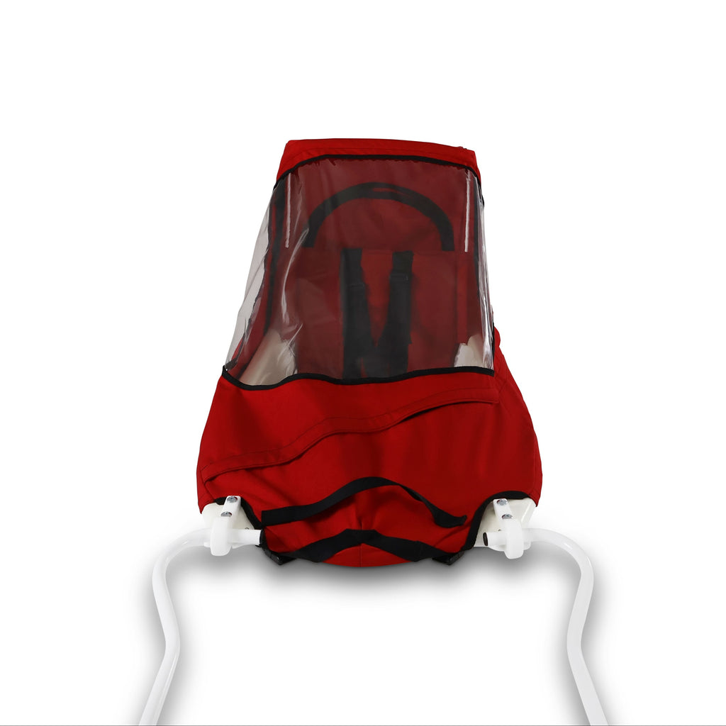 A red KinderShuttle Pulk canopy with a clear plastic window, shown on a white sled against a plain white background.