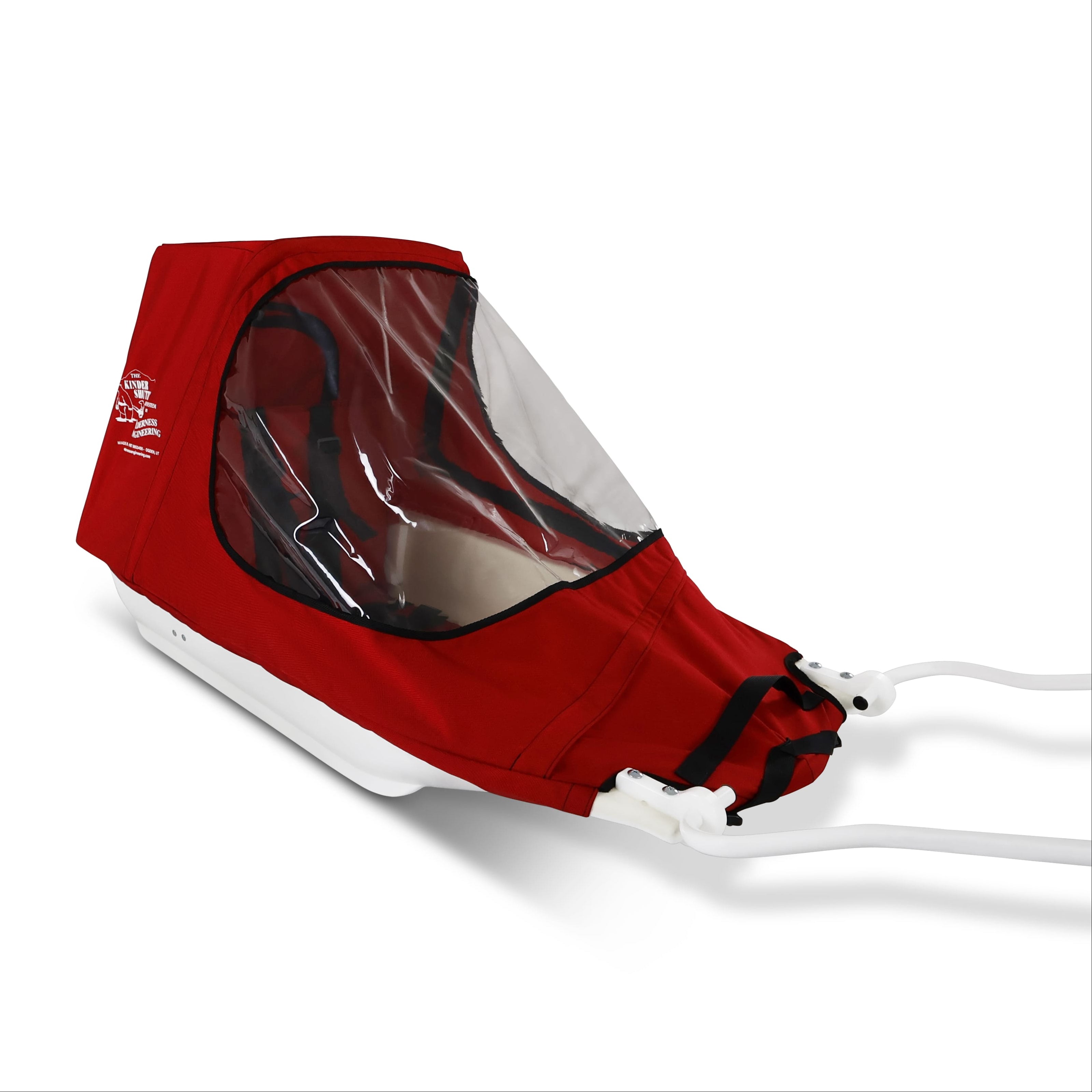 A red KinderShuttle Pulk canopy with a clear plastic window, shown on a white sled against a plain white background.