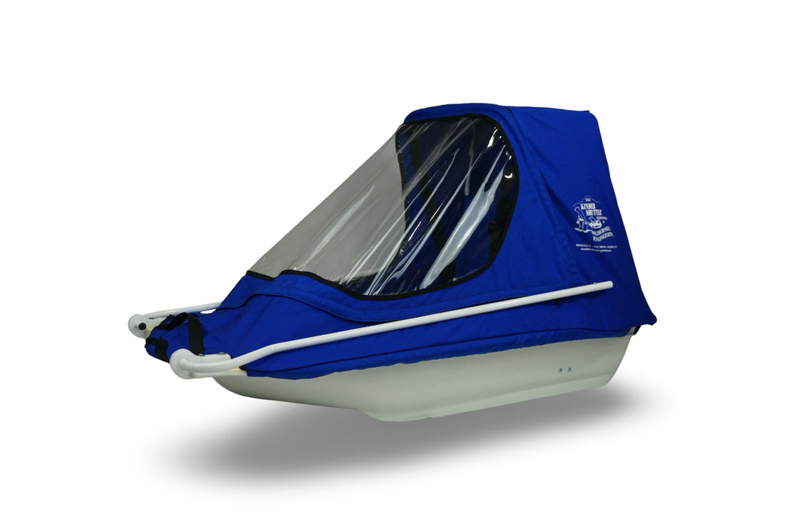 KinderShuttle child sled in blue, quartered view with poles installed, closed configuration